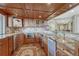 The wood bar features granite countertops, under-cabinet lighting, and a small beverage refrigerator at 9315 E Aspen Hill Ln, Lone Tree, CO 80124