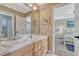 Double vanity bathroom with and sinks and a mirror is attached to the bedroom at 9315 E Aspen Hill Ln, Lone Tree, CO 80124