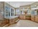 Primary bathroom featuring a large soaking tub and separate vanity areas at 9315 E Aspen Hill Ln, Lone Tree, CO 80124
