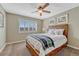 Well-lit bedroom with a bed, ceiling fan, and window with shuttered blinds at 9315 E Aspen Hill Ln, Lone Tree, CO 80124