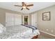 Neutral bedroom features a ceiling fan, a window and a sliding door closet and an ensuite door to the next room at 9315 E Aspen Hill Ln, Lone Tree, CO 80124