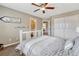 Inviting bedroom with a neutral color palette, a ceiling fan, a window and a sliding door closet at 9315 E Aspen Hill Ln, Lone Tree, CO 80124