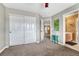 Spacious bedroom has a neutral color palette with door to a bathroom and large closet at 9315 E Aspen Hill Ln, Lone Tree, CO 80124