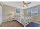 Bright bedroom featuring a white bed frame, shuttered windows, and soft, neutral walls at 9315 E Aspen Hill Ln, Lone Tree, CO 80124