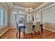 Dining room with hardwood floors, coffered ceiling, and open access to other rooms at 9315 E Aspen Hill Ln, Lone Tree, CO 80124