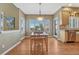 Dining room with table, chairs, light fixture, and windows with wooden shutters at 9315 E Aspen Hill Ln, Lone Tree, CO 80124