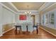 Formal dining room with hardwood floors, tray ceiling, and elegant chandelier at 9315 E Aspen Hill Ln, Lone Tree, CO 80124