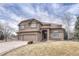 Stately two-story home featuring a three-car garage and stone and stucco exterior at 9315 E Aspen Hill Ln, Lone Tree, CO 80124