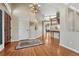 Bright foyer with hardwood floors, chandelier, and view of the second floor at 9315 E Aspen Hill Ln, Lone Tree, CO 80124