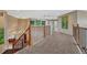 Upstairs hallway featuring new carpet, railing with wooden banister, and neutral paint at 9315 E Aspen Hill Ln, Lone Tree, CO 80124