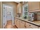 Gourmet coffee bar features granite countertop, stainless steel appliances, and convenient walk-in pantry access at 9315 E Aspen Hill Ln, Lone Tree, CO 80124