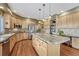 Spacious kitchen features granite countertops, stainless steel appliances, and a large center island with bar seating at 9315 E Aspen Hill Ln, Lone Tree, CO 80124