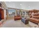 Wide open living room with a built in wall to wall bookcase, lots of seating, and a wet bar at 9315 E Aspen Hill Ln, Lone Tree, CO 80124