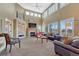 Bright and airy living room with fireplace, large windows, and vaulted ceilings at 9315 E Aspen Hill Ln, Lone Tree, CO 80124