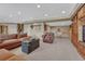 Spacious living room offers comfortable seating, neutral carpet, and recessed lighting throughout at 9315 E Aspen Hill Ln, Lone Tree, CO 80124