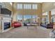 Spacious living room with fireplace and large windows, ideal for entertaining or relaxing at 9315 E Aspen Hill Ln, Lone Tree, CO 80124