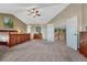 Large main bedroom featuring ensuite bathroom, vaulted ceiling, and walk in closet at 9315 E Aspen Hill Ln, Lone Tree, CO 80124