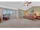 Spacious main bedroom with vaulted ceilings, chair, and multiple windows at 9315 E Aspen Hill Ln, Lone Tree, CO 80124