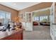 Office space with desk with view to living room area with a large window at 9315 E Aspen Hill Ln, Lone Tree, CO 80124