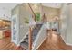 Elegant staircase with wooden banister and view of the foyer at 9315 E Aspen Hill Ln, Lone Tree, CO 80124