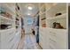 Large walk-in closet featuring custom shelves and storage space at 9315 E Aspen Hill Ln, Lone Tree, CO 80124
