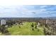 Expansive aerial view showcases a lush green park with walking paths, against a backdrop of the city skyline at 1200 N Humboldt St # 1204, Denver, CO 80218