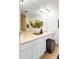 Bright bathroom featuring marble countertops, ample vanity storage and a stylish ottoman at 1200 N Humboldt St # 1204, Denver, CO 80218