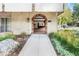 Inviting building entrance with brick archway, well-maintained landscaping, and clear signage at 1200 N Humboldt St # 1204, Denver, CO 80218