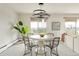 Modern dining room featuring a unique chandelier, round table and seating for four with an expansive view at 1200 N Humboldt St # 1204, Denver, CO 80218