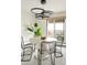 A stylish dining room featuring a unique chandelier, round table and seating for four with a balcony view at 1200 N Humboldt St # 1204, Denver, CO 80218