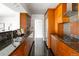 Modern kitchen featuring sleek granite countertops, stainless steel appliances, and ample wood cabinetry at 1200 N Humboldt St # 1204, Denver, CO 80218