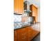 Modern kitchen featuring sleek granite countertops, stainless steel appliances, and ample wood cabinetry at 1200 N Humboldt St # 1204, Denver, CO 80218
