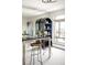 Modern living space featuring a bar with bar stools, built in shelving and an expansive view at 1200 N Humboldt St # 1204, Denver, CO 80218