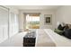 Cozy bedroom with natural light, complemented by chic decor and balcony access at 1200 N Humboldt St # 1204, Denver, CO 80218