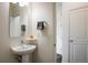 Half bathroom featuring a pedestal sink, mirror, towel rack, and a neutral color scheme at 13725 Ash Cir, Thornton, CO 80602