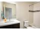 Bathroom with tub, shower, single sink with dark vanity, and tiled walls at 13725 Ash Cir, Thornton, CO 80602