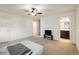 Bedroom featuring neutral carpet, a ceiling fan, access to a bathroom, and ample natural light at 13725 Ash Cir, Thornton, CO 80602