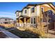 Two-story townhome showcasing neutral exterior paint, a cozy porch, and low-maintenance landscaping at 13725 Ash Cir, Thornton, CO 80602