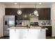 Stylish kitchen with stainless steel appliances, granite countertops, and dark wood cabinetry at 13725 Ash Cir, Thornton, CO 80602