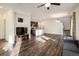 Open-concept living space with hardwood floors seamlessly connecting the living room, kitchen, and staircase at 13725 Ash Cir, Thornton, CO 80602