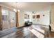 Spacious living area with wood floors, large windows, a ceiling fan, and access to the backyard at 13725 Ash Cir, Thornton, CO 80602