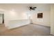 Carpeted loft area featuring a ceiling fan and a view of the windows at 13725 Ash Cir, Thornton, CO 80602