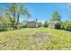 Large green backyard with a small building and a gray home at 4155 S Lipan St, Englewood, CO 80110