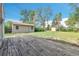 Backyard featuring a shed, a deck, a small fire pit, and large trees at 4155 S Lipan St, Englewood, CO 80110