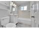 Clean bathroom with white vanity, tiled walls, modern fixtures, and bathtub with shower at 4155 S Lipan St, Englewood, CO 80110