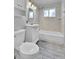 Well-lit bathroom with white vanity, combined tub and shower, and modern gray tiling at 4155 S Lipan St, Englewood, CO 80110