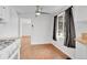 Dining room with hardwood floors, white walls, curtains, and modern ceiling fan at 4155 S Lipan St, Englewood, CO 80110