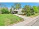 Charming single-story home with a well-maintained lawn, covered front porch, and convenient driveway at 4155 S Lipan St, Englewood, CO 80110