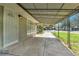 Long front porch entrance with a white security door, concrete patio, and metal awning at 4155 S Lipan St, Englewood, CO 80110