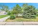 Landscaped front yard showcasing mature trees and a well-maintained lawn at 4155 S Lipan St, Englewood, CO 80110